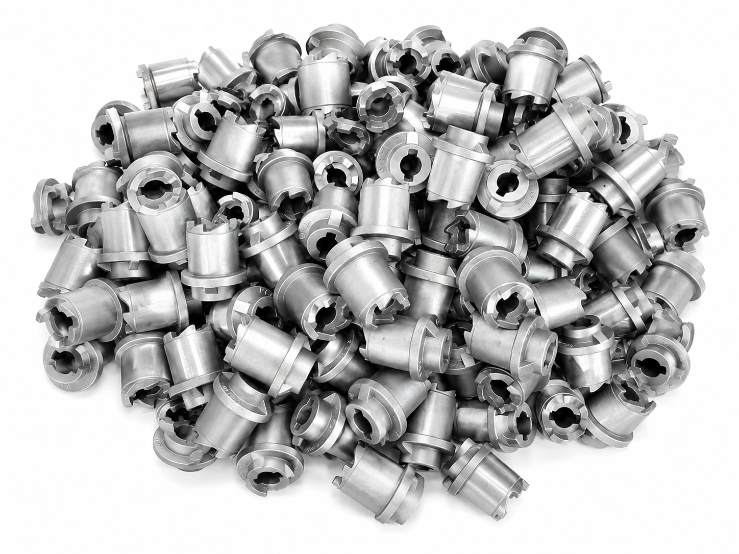 Bulk carbon steel cast components with keyed bores and precision-machined profiles for industrial manufacturing on a white background.